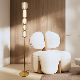 "This Lyris floor lamp showcases a vertical design with stacked glass orbs and a luxurious gold metal base. It combines artistic elegance and functionality, ideal for living rooms or offices. Material: metal, glass, acrylic."