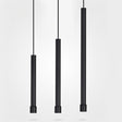 "Three sleek cylindrical aluminum pendant lights, black finish, suspended with linear cords"