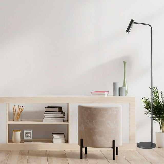 "Minimalist floor lamp with an aluminum frame positioned in a stylish office setting"