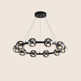 "Modern chandelier with aluminum frame and smoked glass orbs, suspended from the ceiling."