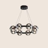 "Chandelier with smoked glass orbs and aluminum frame viewed from below."