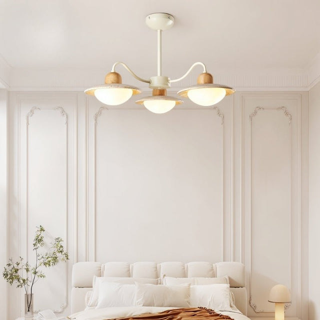"Chandelier lighting a cozy bedroom, curved arms, natural materials, diffused glow"