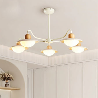 "Minimalist chandelier with curved arms, warm diffused light, natural wood and travertine materials, living room decor"