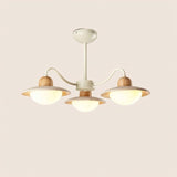 "Small minimalist chandelier with warm lampshades, curved arms, wood and travertine details"