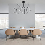 "Minimalistic chandelier with angular arms and LED lights, suspended above a dining table in a sleek modern dining room."