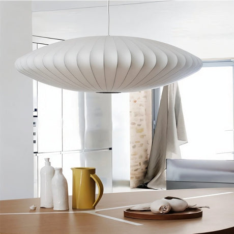 "Close-up of a modern pendant light above a wooden dining table with minimalist decor and soft natural lighting."