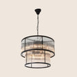 "A detailed view of a round chandelier featuring ribbed glass panels and a sturdy iron frame, showcasing its modern industrial design."