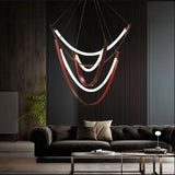 "Contemporary chandelier with layered glass arcs and leather straps, creating depth and warmth in a luxurious living room."