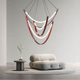 "Minimalist room featuring a modern chandelier with leather straps and glowing glass, providing warm ambient lighting."