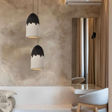 "Pendant lamps with two-tone finish hanging in modern bedroom corner near mirror and chair"