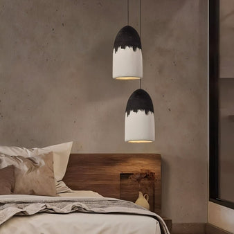 "Pendant lamps with two-tone finish hanging over cozy modern bedroom"