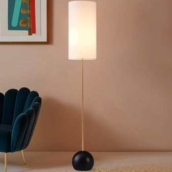 "Floor lamp with cylindrical fabric shade, slim wooden pole, spherical base, modern living room setup."