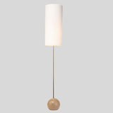 "Wooden spherical base detail, minimalist floor lamp, ambient lighting fixture."