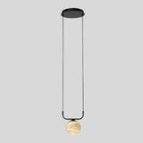 "Single pendant lamp featuring a spherical alabaster shade and black fixture, offering a soft, diffused glow that adds a touch of elegance to contemporary interiors."