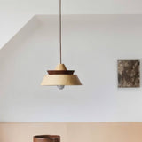 "Wooden pendant light featuring a minimalist layered design, ideal for creating a warm and cozy atmosphere in contemporary spaces."