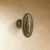 Ornate white ceramic cabinet knob with decorative carved detailing and beaded trim, shown from front angle with measurements.