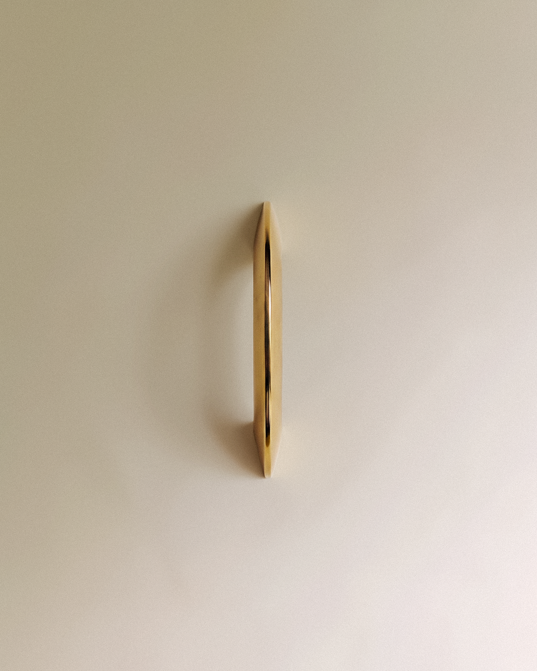 Enzo Cabinet Pull 2" in Unlacquered Brass front view, on a plain background