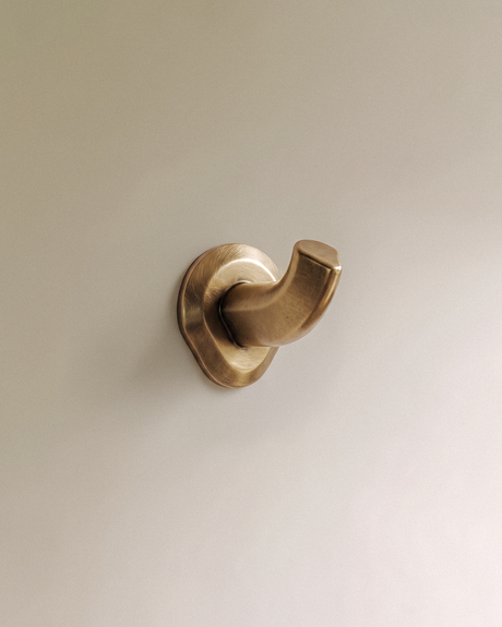 Enzo Wall Hook in Unlacquered Brass, on a plain background