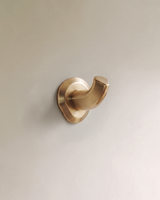 Enzo Wall Hook in Satin Brass, on a plain background