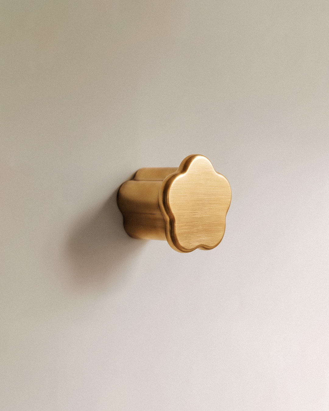 Gatsby Cabinet Knob in Satin Brass, on a plain background