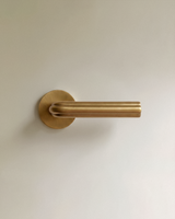 Gatsby Door Handle in Satin Brass, on a plain background