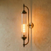 Polished chrome cylindrical wall-mounted sconce with vertical ribbed glass shade, mounting bracket, and decorative finial on