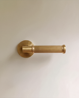Vestige Door Handle in Satin Brass, on a plain background