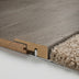 Close-up of laminate flooring edge with soft textured carpet, showcasing wood grain and smooth finish.