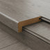 Close-up of a wooden stair edge in a sleek gray finish, featuring a curved profile and a contrasting light wood accent.