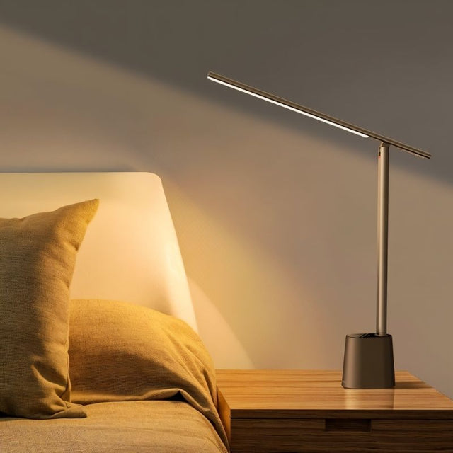 "Modern table lamp with aluminum and polycarbonate material placed on bedside table, offering focused illumination."