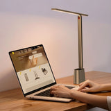 "Sleek table lamp on a desk, crafted from aluminum and polycarbonate, providing focused lighting for workspaces."