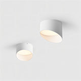"Two cylindrical ceiling lights, white finish, flush-mounted, sleek modern design"