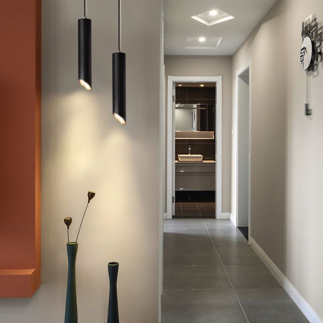 "Modern black pendant light in hallway, aluminum construction, focused downward lighting, contemporary design"