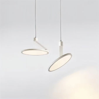 "Two modern pendant lights with circular LED panels, adjustable cables, sleek minimalist design, metal and plastic materials"