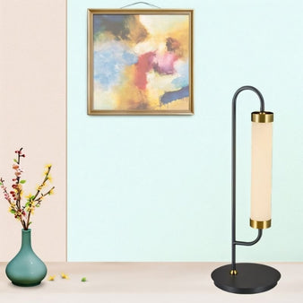 "Minimalist table lamp with glass and gold accents placed in a stylish home setting"