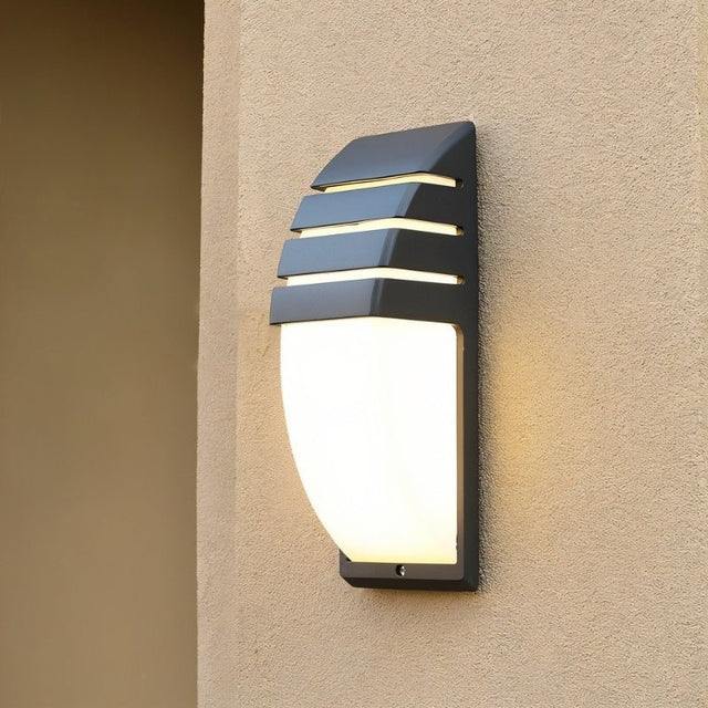 "Weatherproof outdoor wall lamp with horizontal slats, made of durable aluminum, creating a soft warm glow."
