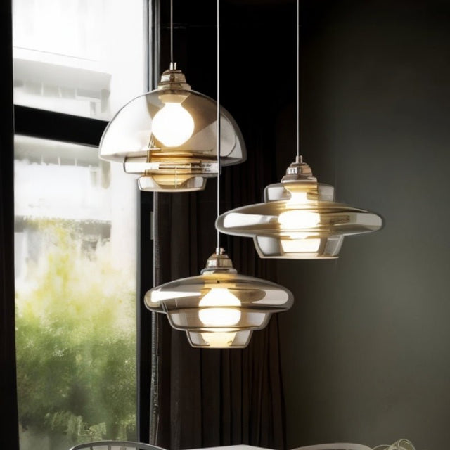 "A modern pendant light with a transparent glass shade and metallic accents, offering excellent illumination."