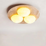 "Close-up of ceiling lamp, natural travertine base, glowing opal glass globes, elegant design"
