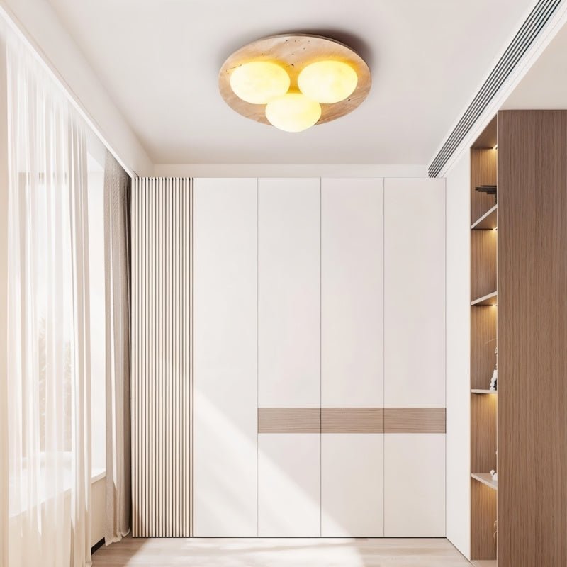 "Ceiling lamp in minimalist room, circular travertine base, warm glowing opal glass globes, sleek modern lighting"