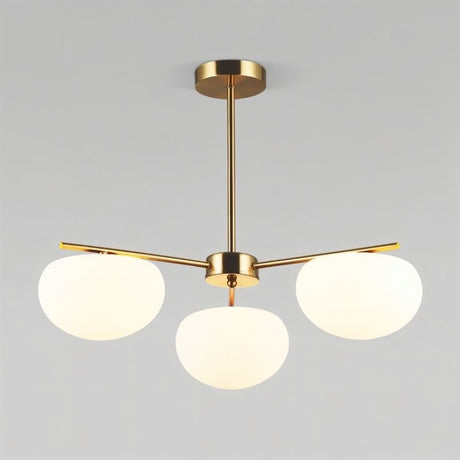 "Golden pendant lamp with three glass shades, adding elegant lighting to a modern living room."