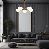 "Golden pendant lamp with spherical glass shades, enhancing a modern dark-themed living room."