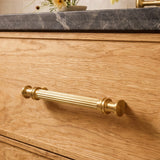 Vestige Cabinet Pull in Satin Brass, styled interior