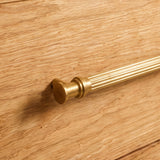Vestige Cabinet Pull in Satin Brass, styled interior