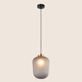 "Minimalist pendant light with clear glass shade and gold accent, ideal for stylish modern interiors."