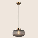 "Pendant light with Cylinderical Clear glass shade and elegant gold finish, providing a modern and sophisticated touch."