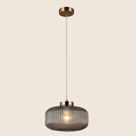 "Pendant light with Cylinderical Clear glass shade and elegant gold finish, providing a modern and sophisticated touch."