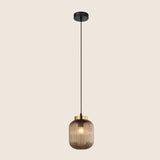 "Modern pendant light featuring a gold glass shade and black fixture, ideal for contemporary home décor."