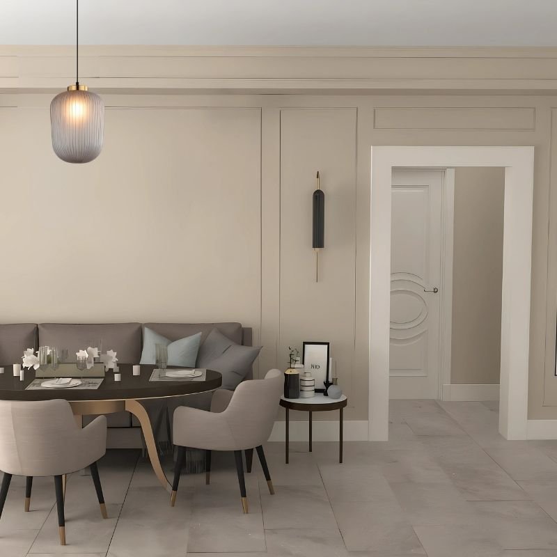"Glass and iron pendant light, featuring a minimalist design, hanging over a dining table in a stylish, contemporary dining room."