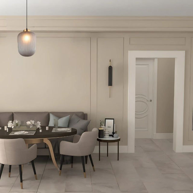 "Glass and iron pendant light, featuring a minimalist design, hanging over a dining table in a stylish, contemporary dining room."