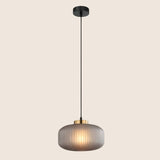 "Pendant light with soft gray glass shade and elegant gold finish, providing a modern and sophisticated touch."